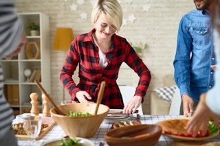 person setting the table for a holiday party