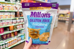 hand holding a bag of miltons crackers