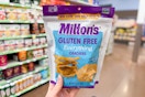 hand holding a bag of miltons crackers