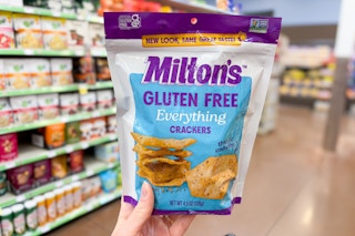 hand holding a bag of miltons crackers