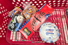 ball park buns and hot dogs, breyers ice cream, coca-cola, and dixie paper plates in a cart