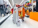Halloween costumes hanging on the back of a Target shopping cart