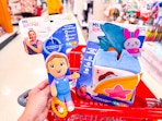 hand holding a ms rachel toy at target