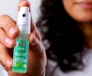 a person holding a breath spray bottle