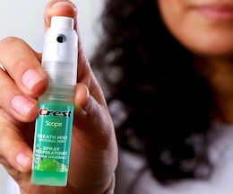 a person holding a breath spray bottle