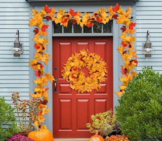 fall leaves framing a front door to a house
