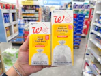 hand holding walgreens trash bag packs