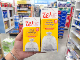 hand holding walgreens trash bag packs