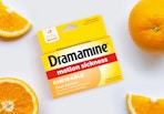 a pack of Dramamine next to orange slices