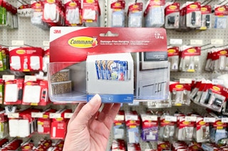 hand holding a command storage caddy in front of other hardware at target