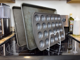 Baking trays stacked vertically on a stove