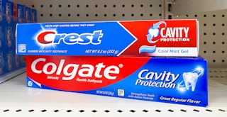 stacked boxes of crest and colgate cavity protection boxes on store shelf