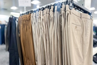 in store photo of Macy's dress pants hanging on a rack