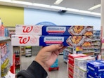 hand holding walgreens aluminum foil packs