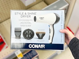 hand holding conair hair dryer in walgreens