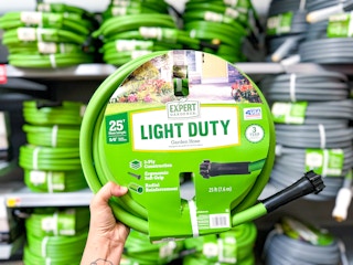 hand holding a 25' green garden hose