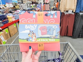 hand holding a 2 pack of bluey tshirts