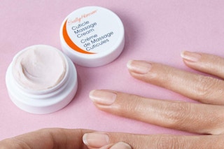 a person putting cuticle cream on their hands