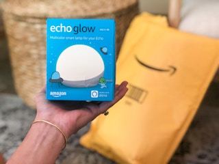 Hand holding an Amazon Echo Glow in the box