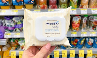 hand holding pack of aveeno baby wipes