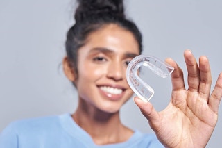 a woman holding a clean retainer