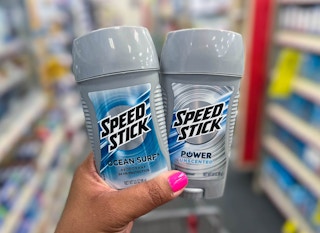 hand holding two Speed Stick deodorants
