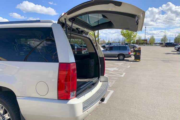 A vehicle with an open trunk waiting for a grocery pickup order.