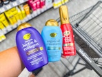 person holding OGX hair care