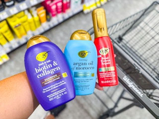 person holding OGX hair care