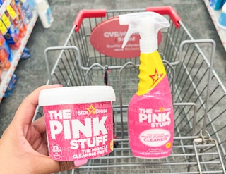 hand holding The Pink Stuff paste next to the cleaner spray in shopping cart
