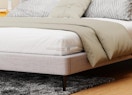 clear sheet holder on the corner of a bed