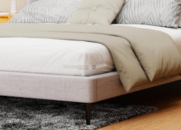 clear sheet holder on the corner of a bed