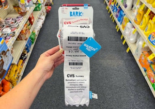 someone holding cvs receipt with coupons on it