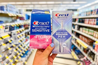 hand holding package of whitestrips and whitening pen in store aisle
