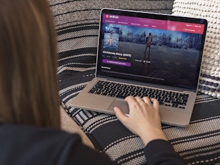 person at home streaming a christmas movie on laptop