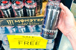 hand holding a monster energy drink