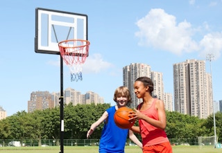 children playing basketball with the basketball hoop