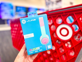 A box of JLab Jbuddies Kids' headphones in front of a Target cart