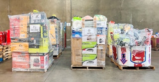 Pallets of merchandise from stores like Target sitting on the floor of a liquidation store
