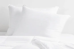 two queen pillows in white bedding