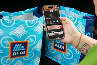 someone looking at the doordash app next to some Aldi bags