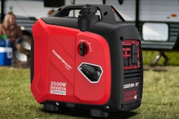 gas generator on the grass in front of an RV camper