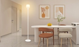 a floor lamp in a room next to a table and chairs