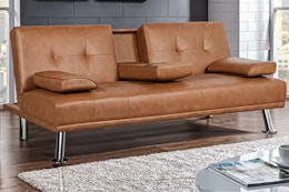 Lifestyle image of the brown Renwick LuxuryGoods Modern Faux Leather Futon in home setting