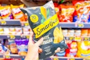 hand holding a bag of smartfood popcorn
