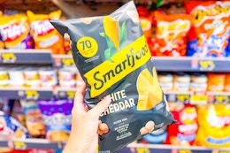 hand holding a bag of smartfood popcorn