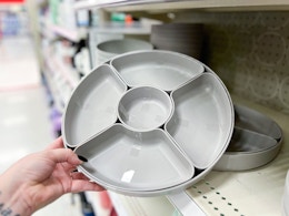 hand grabbing a serving platter set off a target shelf