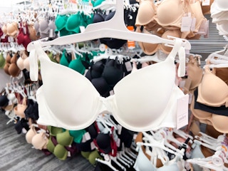 holding up a bra on a hanger at Target