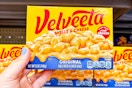 hand holding a box of velveeta shells and cheese