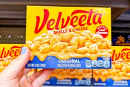 hand holding a box of velveeta shells and cheese